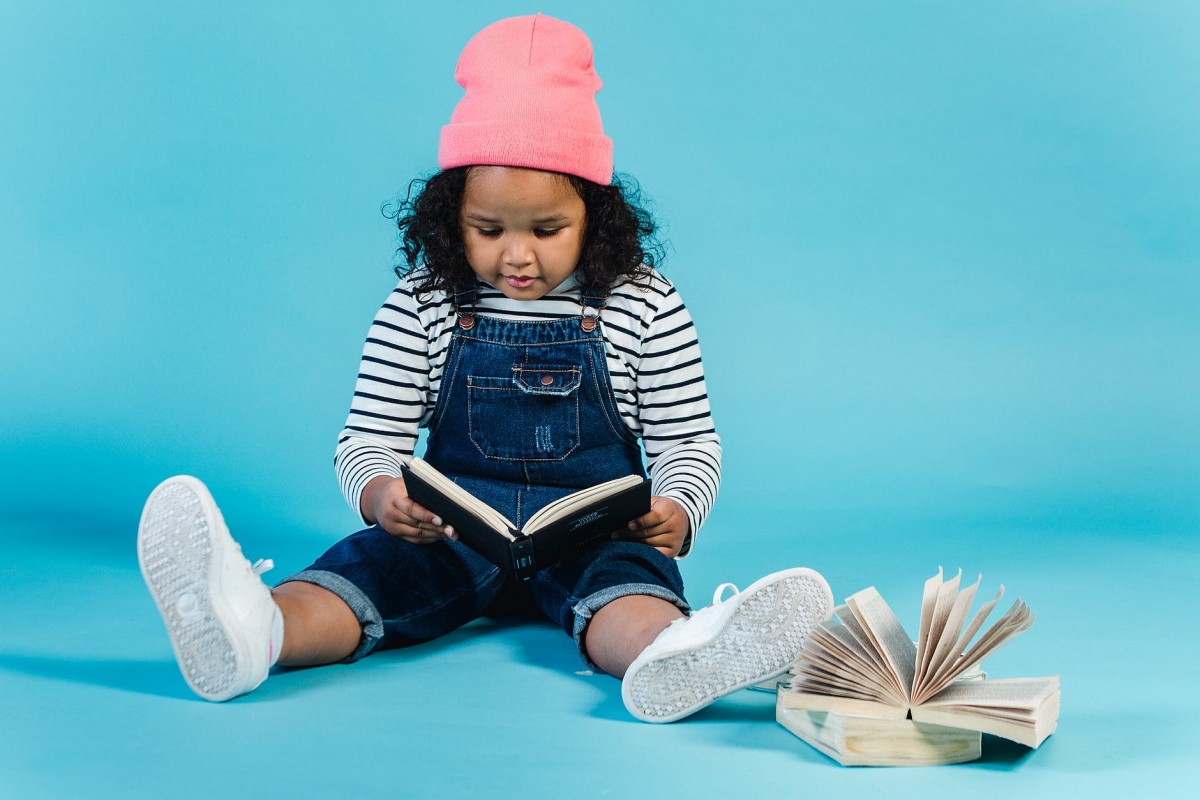 adorable black girl reading interesting book